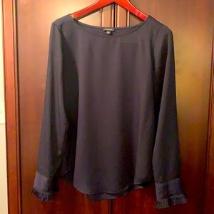 Navy Blouse with ruffle detail on sleeves.